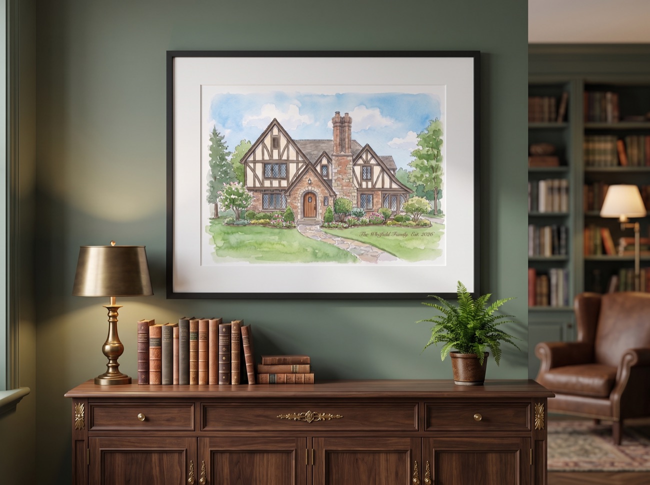 Framed watercolor portrait of a Tudor home displayed above a console
